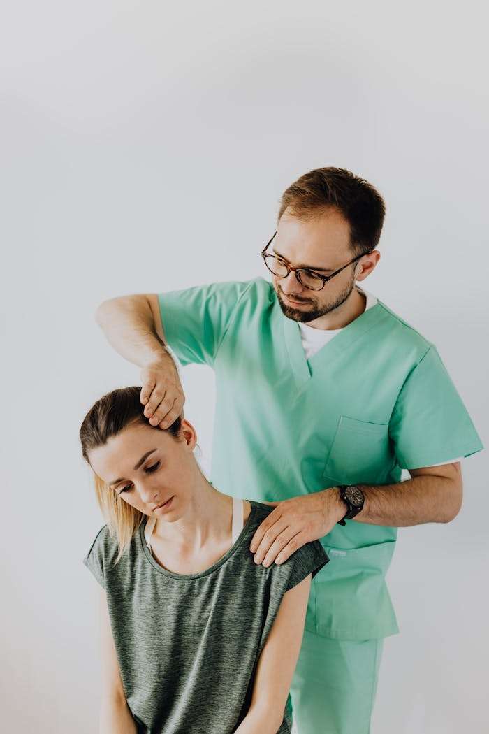 Professional Massage Therapist Treating a Female Patient's Injured Neck